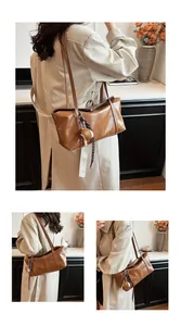 Close-up of glossy brown leather tote bag with elegant fish pendant and slim straps