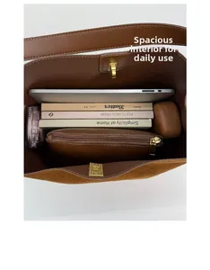Spacious interior of brown suede bucket bag with laptop and books for daily use