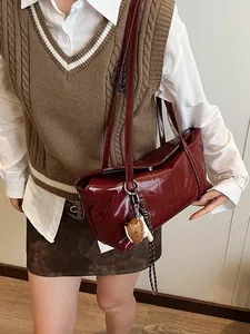 Retro dark red glossy leather shoulder bag with baseball glove pendant and shoulder strap