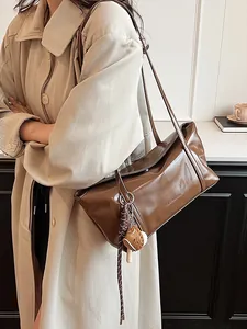 Brown oil wax leather underarm bag with creative baseball glove charm and clearok logo
