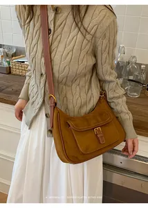 Brown faux suede hobo bag styled on model for a minimalist sophisticated retro look