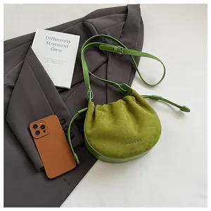 Detailaufnahme der grasgrünen Wildledertasche mit feiner Faltenstruktur und Raffung