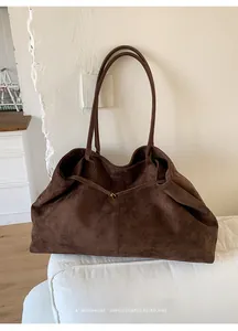 Detail view of deep brown suede tote bag showing soft texture and spacious interior