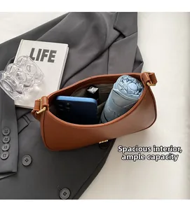 Brown PU leather shoulder bag showing spacious interior with phone and umbrella