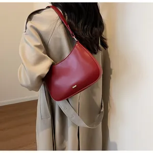 Detailed back view of a dark red crescent shoulder bag with smooth leather texture
