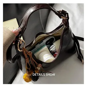 Internal capacity of dark brown leather handbag with phone and cosmetics