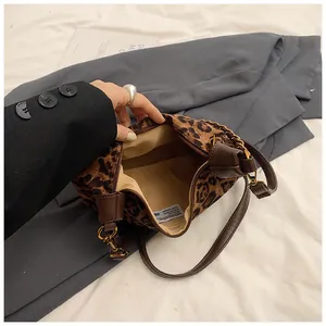 Macro detail of leopard print bag interior showing the zipper closure and lining