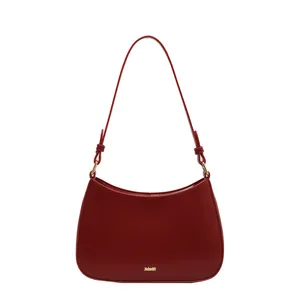 Minimalist dark red leather hobo bag with a half-moon shape and golden logo