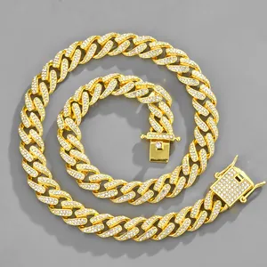 Detailed close-up of golden Cuban link chain with sparkling pavé zircons and secure box clasp