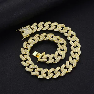 Macro shot of 19mm gold plated Cuban chain necklace with iced out rhinestones on black