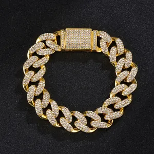 Detailed view of 15mm gold-toned Cuban link chain with paved rhinestones on black background