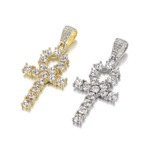Gros plan des pendentifs Ankh en or et argent avec incrustation de strass denses