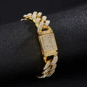 Macro shot of gold-plated cuban chain link with pave-set rhinestones and a box clasp