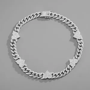Close-up of silver Cuban link necklace with heart charms and pavé set rhinestones