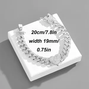 Macro detail of iced-out silver cuban link bracelet with a heart pendant and size info
