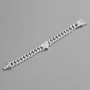 Detail of silver Cuban chain bracelet with iced out heart link and pave zircons