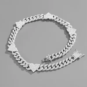 Macro shot of silver hip-hop Cuban chain necklace featuring five iced-out heart pendants