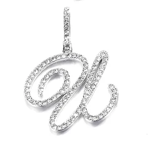 Macro detail of silver cursive letter W pendant with full iced out zircon stones