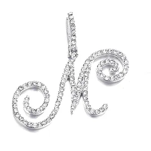 Macro shot of a silver letter M pendant with dense pave setting of white cubic zirconia