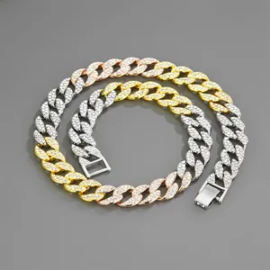 Detailed view of tri-color iced-out Cuban link chain with gold, silver and rose gold links