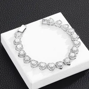 Macro view of silver heart zircon tennis bracelet with paved stones and buckle closure