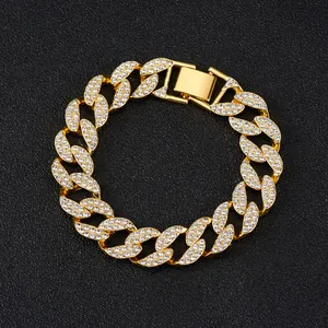 Detail view of gold Cuban link bracelet featuring iced out rhinestones and square clasp