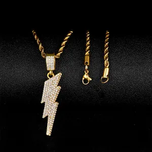 Macro shot of gold hip hop lightning pendant with dense rhinestones on a black stand