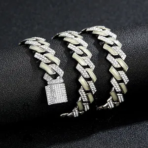 Macro shot of 15mm silver cuban chain with paved diamonds and light cyan enamel details