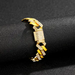 Macro detail of 15mm gold Cuban link chain with paved rhinestones and secure box clasp