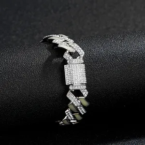 Macro shot of iced out silver Cuban link chain with pave rhinestones on black display