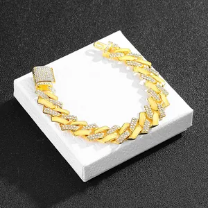 Detail of 15mm gold Cuban link necklace with white pavé rhinestones on jewelry box
