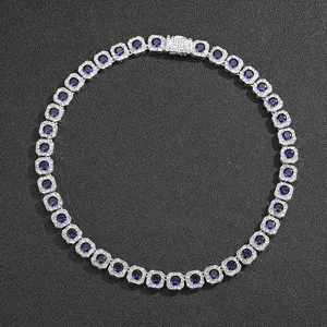 Detail of silver tennis necklace with deep blue round center stones and pavé set clasp
