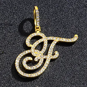 Iced out gold cursive letter F pendant necklace with pavé cubic zirconia crystals