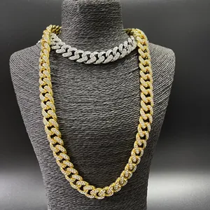Close-up of gold and silver iced out Cuban link chains with shimmering crystals