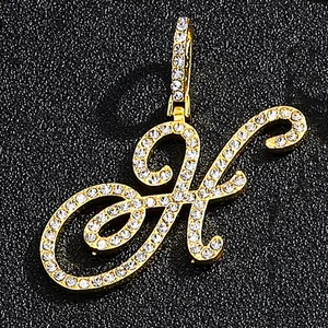 Iced out gold cursive letter H pendant with shimmering crystals in hip hop style