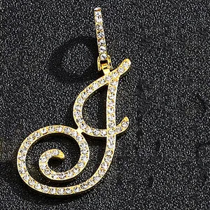 Iced out cursive letter J pendant with gold finish and white crystals on a black base