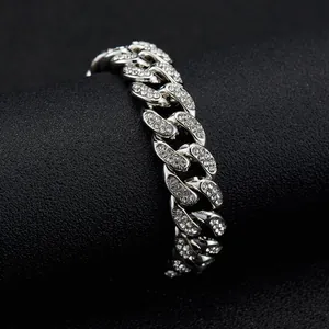 Detailed close-up of a silver Cuban link chain with sparkling pavé-set stones on a black stand