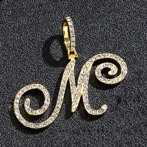 Cursive letter M pendant in gold finish with iced out cubic zirconia pavé setting