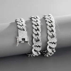 Close-up of iced out silver Cuban chain with broken heart links on a gray jewelry stand