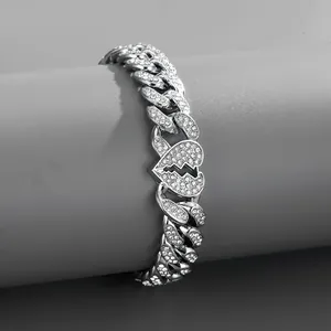 Detailed view of silver iced-out Cuban link bracelet with a broken heart centerpiece