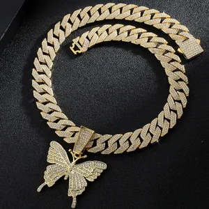 Macro view of gold Cuban chain necklace with a large crystal butterfly pendant