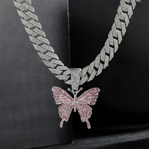 Close-up of hip-hop Cuban link chain featuring a large pink rhinestone butterfly pendant