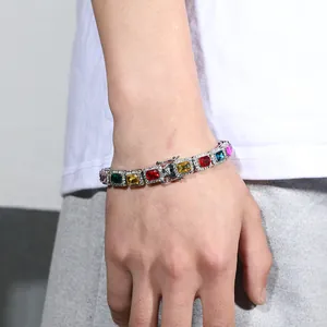 Detail of hip-hop colorful gemstone bracelet with silver metal base on male model