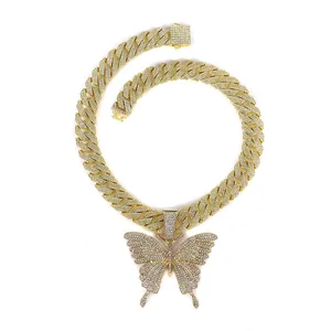 Close-up of hip hop butterfly pendant with rhinestones on a gold Cuban chain