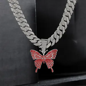 Iced-out Cuban link chain with a red crystal butterfly pendant in hip-hop street style