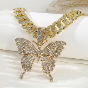 Close-up of hip-hop butterfly pendant necklace with iced-out Cuban link chain in gold