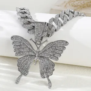 Iced out Cuban link chain necklace with a large crystal encrusted butterfly pendant