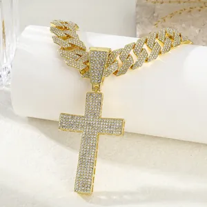 Iced out gold Cuban link chain necklace with a large crystal cross pendant for men