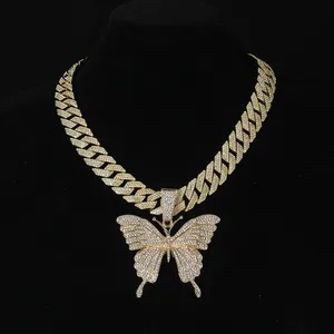 Close-up of iced-out gold Cuban chain set with large rhinestone butterfly pendant