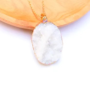 Detail van natuurlijke druzy kwarts hanger met goud vergulde onregelmatige randen